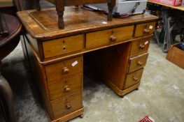 A small Victorian pine kneehole desk.