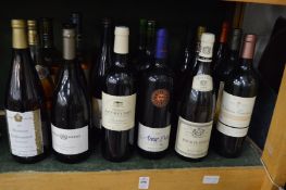 Eighteen bottles of white and rose wine.