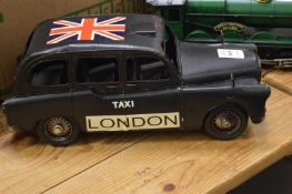 Tin plate model of a black taxi.