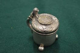 A small silver model of a peg tankard inset with a coin (29).