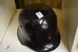 A German black steel helmet with Police Decal.