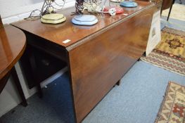 A George III design mahogany three part dining table with a central drop-leaf section and a pair