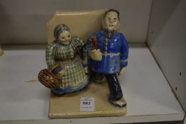 An unusual pottery model of a man and a women.