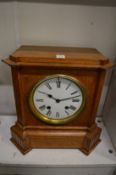 An oak cased mantel clock.