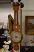An oak cased thermometer and barometer.