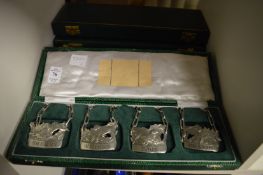 Three boxed sets of four cast pewter decanter labels.