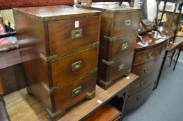 A pair of military style three drawer pedestal chests.