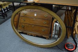 An oval wall mirror.