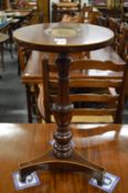 A small mahogany occasional table with painted oval panel.