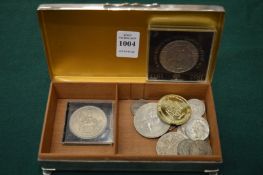 A cigarette box containing coins.