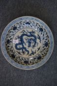 A Chinese blue and white crackle glazed circular dish decorated with dragons and flowers.