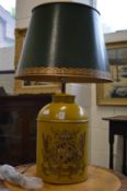 A large yellow and green Toleware style tea canister table lamp with armorial decoration.