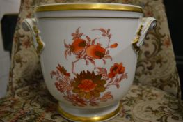 White ground Cachepot decorated in red and gold with flowers.