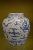 A large Chinese blue and white jar decorated with dragons.