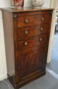 A 19th century mahogany narrow cabinet with three drawers above a panelled door.