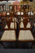 A set of four walnut low back dining chairs and a pair of similar high back chairs.