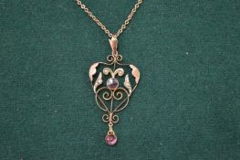 A decorative gold pendant and chain.