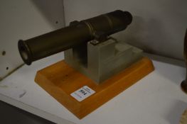 A small bronze model of a cannon.
