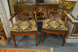 A good pair of satin wood and painted armchairs with cane work cresting rails, central oval panels