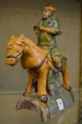 Chinese Sancai glazed rigged tile modelled as a man on horseback.
