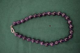 An amethyst bead necklace.