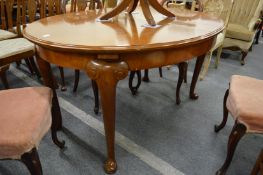 A mahogany oval extending dining table.