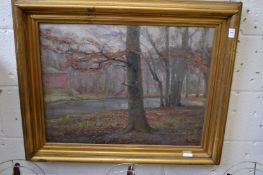 Woodland river landscape, building beyond, oil on canvas, signed and dated 1916.
