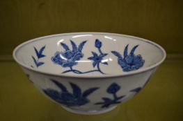 Chinese blue and white bowl decorated with bands of flowers.