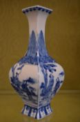A Chinese blue and white decorated square form baluster shaped vase.