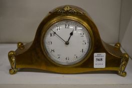 A brass mantel clock.