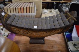 An unusual carved wood boat shaped xylophone.