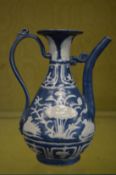 A Chinese blue and white ewer with engraved decoration.