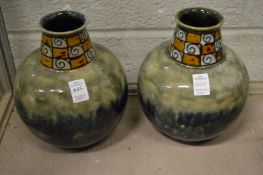 A pair of Royal Doulton bulbous shaped vases.