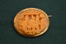 An unusual Chinese carved brooch with yellow metal mount.