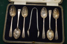 A cased set of six silver coffee spoons with sugar tongs.