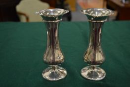 A pair of small silver vases.