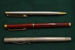A silver Waterman pen and two other pens.