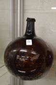 A large amber colour glass bottle.