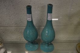 A pair of Eastern gilt decorated turquoise opaque glass water sprinklers.