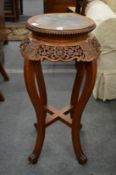 A Chinese hardwood and marble inset urn stand.