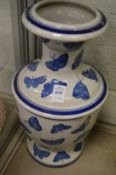 A large blue and white vase decorated with butterflies.