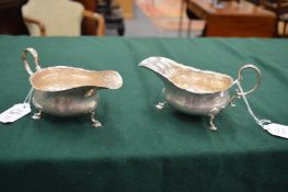 A pair of silver sauce boats.