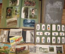 POSTCARDS, a large collection of postcards in three albums and loose; together with a cigarette card