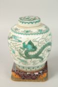 A CHINESE FAMILLE VERTE PORCELAIN DRAGON JAR AND COVER with stand. Jar 18.5cms high.