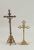 TWO BRASS CRUCIFIX. 33cms and 26cms long.