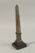A GRAND TOUR BRONZE OBELISK BAROMETER on a stepped base. 30cms high.