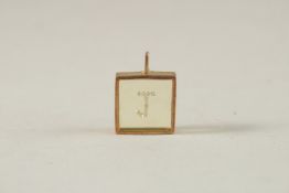 A GOLD FRAMED PENDANT, set with diamonds forming the letter 