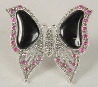 A SILVER ART DECO STYLE ONYX AND RUBY BUTTERFLY BROOCH.