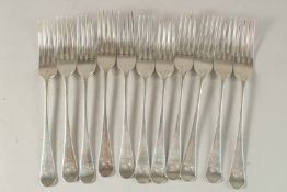 A SET OF ELEVEN GEORGE III SILVER OLD ENGLISH PATTERN TABLE FORKS with lion crest. London 1803.