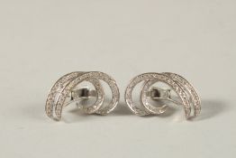 A PAIR OF 18CT WHITE GOLD AND DIAMOND SCROLL SHAPED EAR CLIPS.